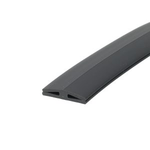 Close-up of a gray U-shaped plastic extrusion with hollow rectangular openings along the edge, diagonally oriented across a white background.