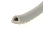 Cross-section of a light-gray foam extrusion showing a circular hollow channel inside, viewed at an angle