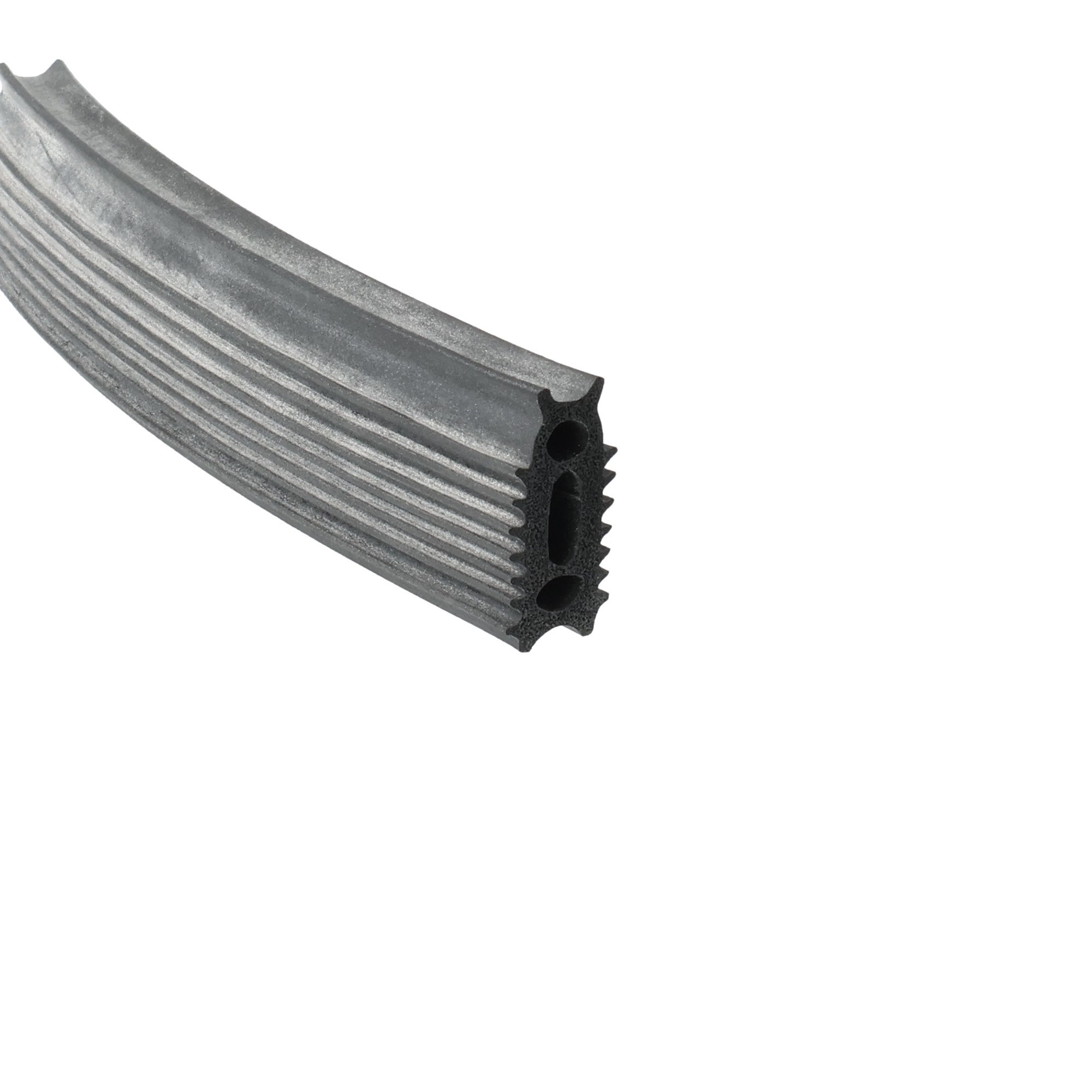 uszczelka-pokrywy-wpinana-gumowa-pianka-4-wargowa-85-x-245mm-czarna-54-315-1 - Centrum uszczelek Close-up of a gray corrugated rubber extrusion with ribbed surface and round hollow channels.