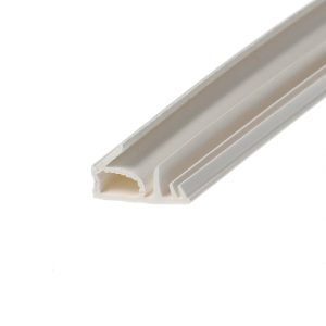 Close-up of a white plastic extrusion with hollow channels, a frame profile viewed diagonally across the image.