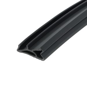 Close-up of a black rubber weatherstrip with a U-shaped hollow channel run diagonally across the frame.