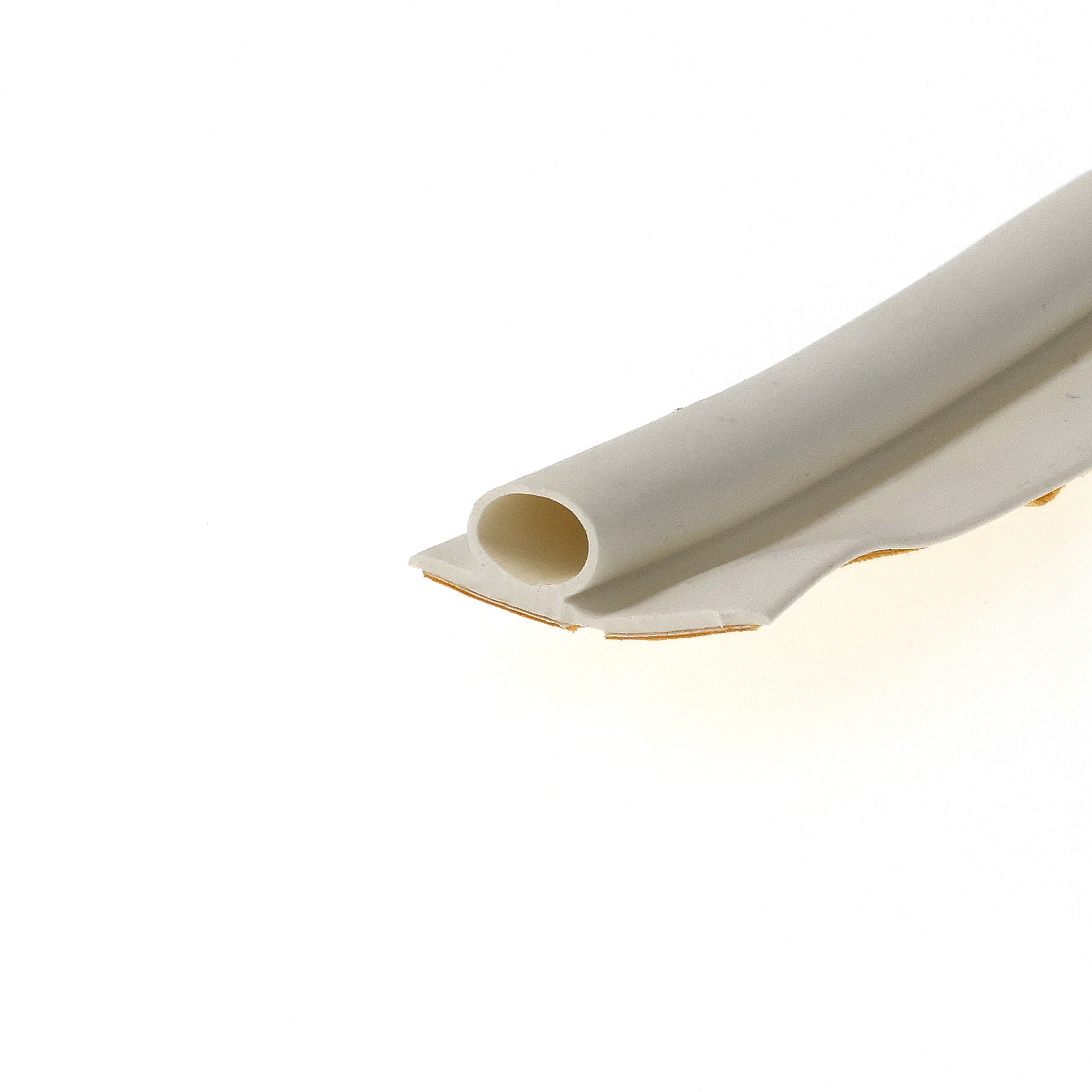 uszczelka-samoprzylepna-do-okien-i-drzwi-6-x-95-x-19mm-biala-09-910-2 - Centrum uszczelek Close-up of a white rolled sheet or tubing with hollow cylindrical cores resting on a white surface.