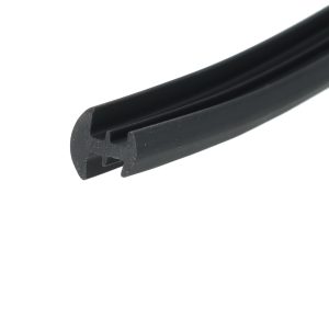 Close-up of a black curved plastic rail with a U-shaped groove and rounded edge.
