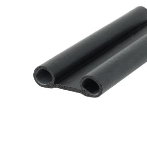 Close-up of black foam pipe insulation cylinders with hollow cores showing a textured surface.