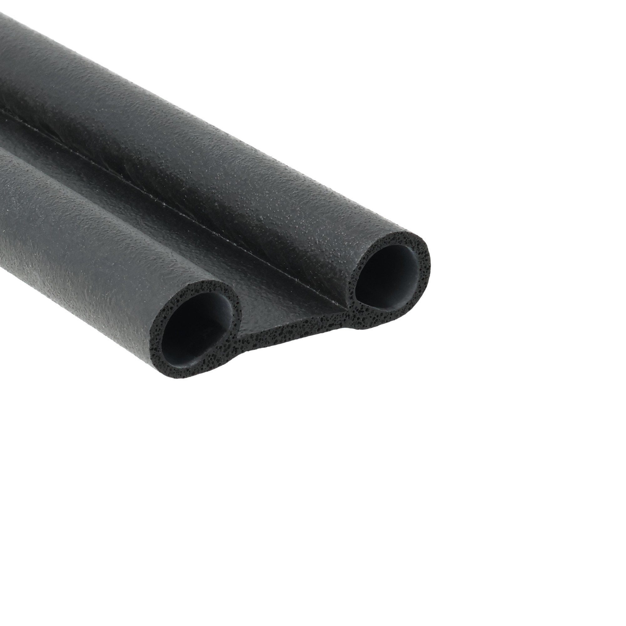 uszczelka-typu-buszczelka-gumowa-okulary-12-054-1585-2 - Centrum uszczelek Close-up of black open-cell foam tubing with hollow centers, arranged diagonally across the frame.