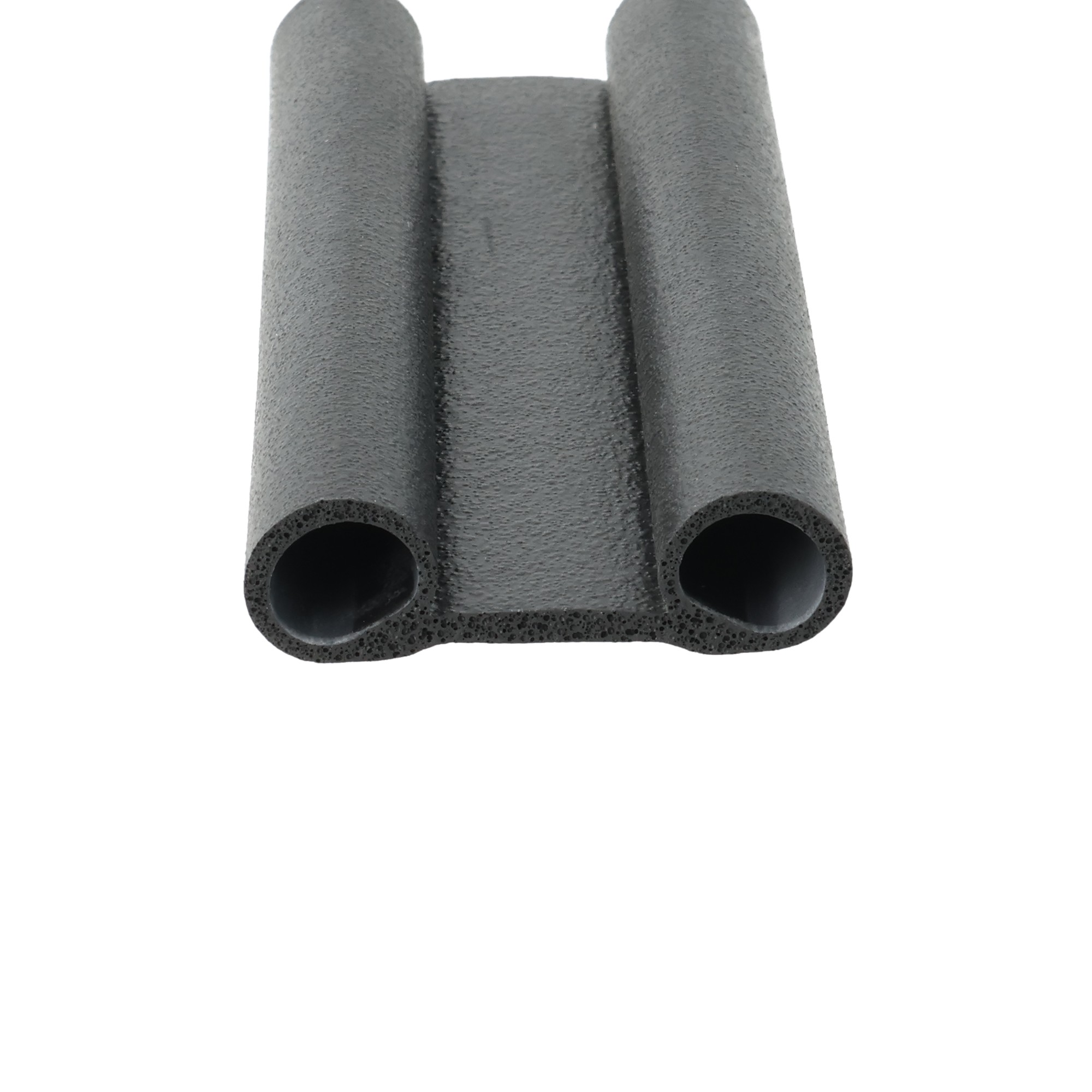 uszczelka-typu-buszczelka-gumowa-okulary-12-054-1585-3 - Centrum uszczelek Close-up of three black foam tubes with hollow centers, likely foam pipe insulation parts.
