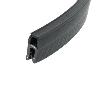 Close-up of a black rubber extruded sealing profile with hollow channels in cross-section.