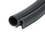 Close-up of a black foam tube showing a hollow circular cross-section and textured outer surface with ridges