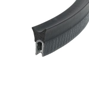 Close-up of a black textured bicycle handlebar grip with a visible foam core and metal clamping ring at the end under angled lighting.