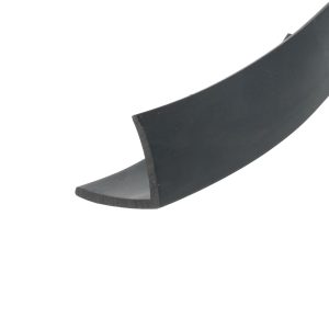 Close-up of a curved dark metal blade or strip with beveled edge against a white background.