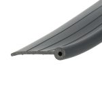Close-up of a grey, ridged plastic or metal edge running diagonally across the image, with a rounded end and a circular hole visible.