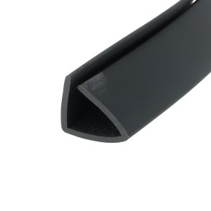 Close-up of a dark, matte black curved edge or corner of a metal/plastic object, showing a rounded inner edge.