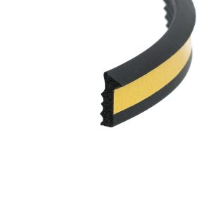 Close-up of a black curved foam strip with a yellow edge stripe, showing its cross-section.