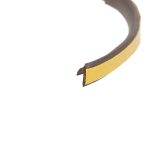 Close-up of a yellow leather belt curved through the frame, showing brown inner side and belt tip.