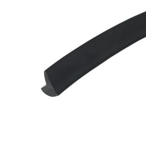 Close-up of a dark curved object with a rounded end against a white background.