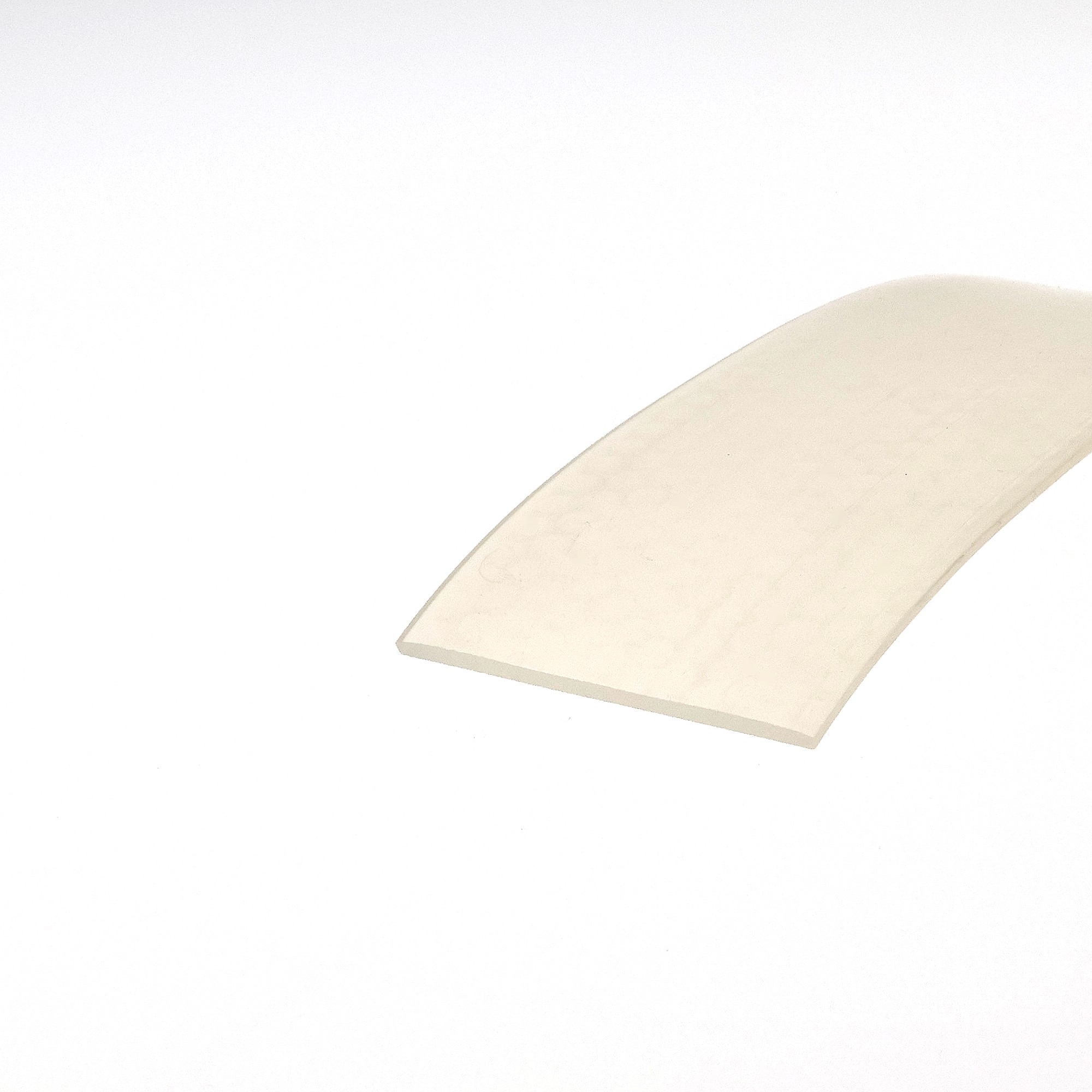 uszczelka-silikonowa-lita-2-x-50mm-bezbarwna-023250-2 - Centrum uszczelek Abstract beige curved shape occupying the bottom-right corner on a white background, resembling a soft, folded surface.