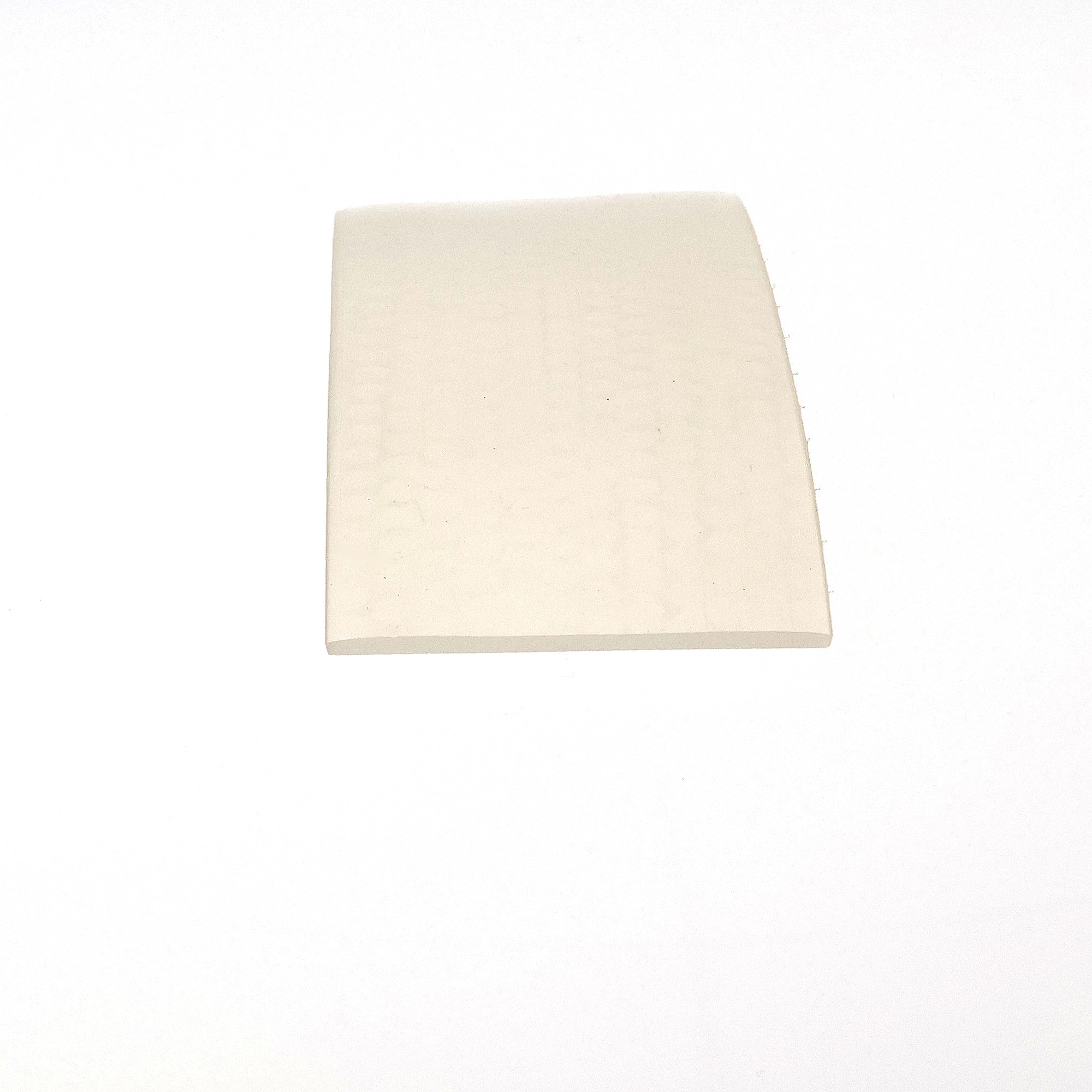 uszczelka-silikonowa-lita-2-x-50mm-bezbarwna-023250-3 - Centrum uszczelek Beige rectangular sheet occupying the lower center of a white background, with slightly curled edges.