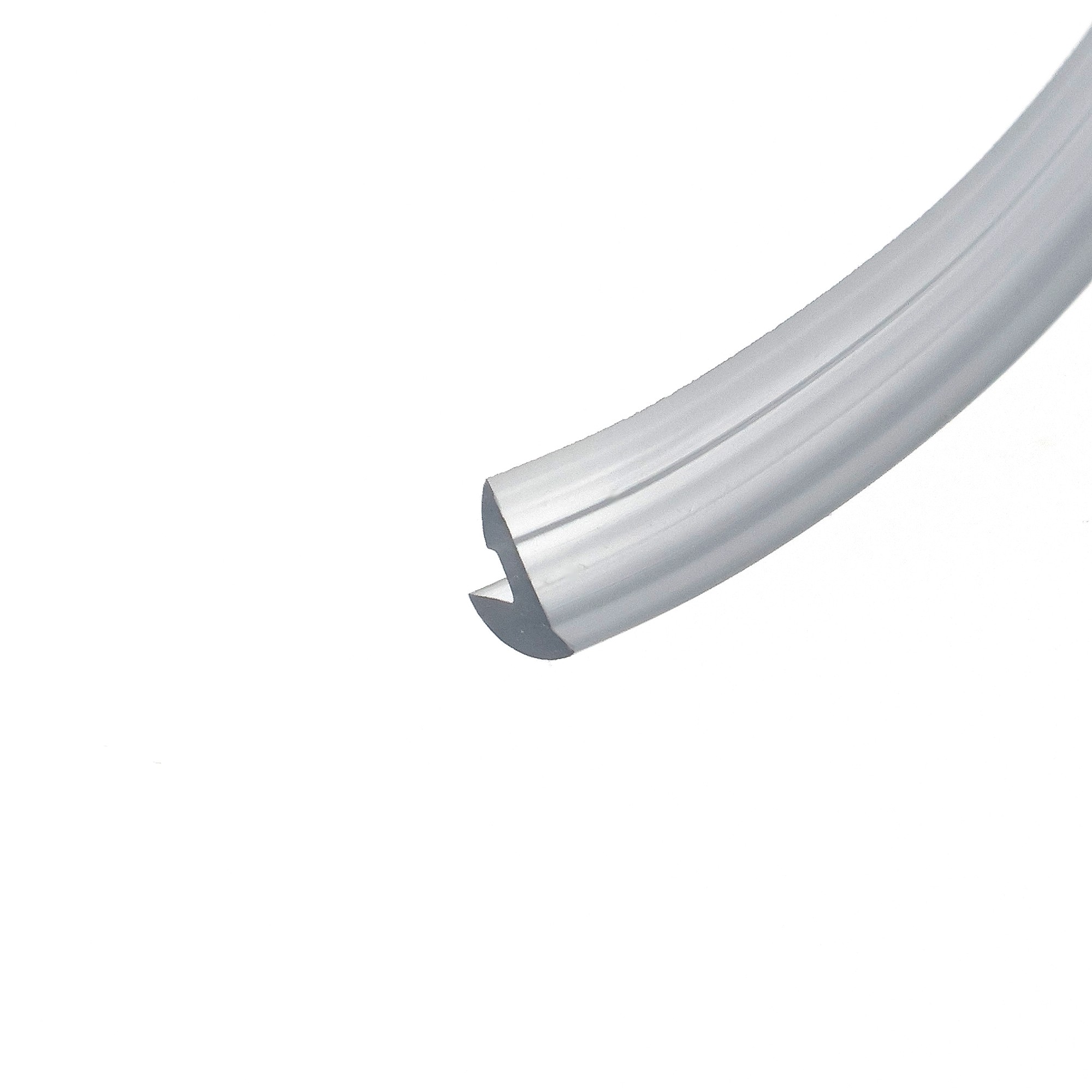 uszczelka-klinujaca-szybe-bezbarwna-026085-01-3 - Centrum uszczelek Curved silver metal extrusion taking up the bottom-right corner against a white background, photographed in close-up.