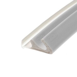 Close-up of a white plastic device with a textured light-gray surface running diagonally across the frame, viewed at an angle.