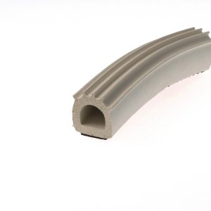 Close-up of a gray foam gasket with a hollow circular core and ribbed exterior surfaces seen at an angle.