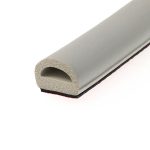 Close-up of a beige porous foam cylinder inside a gray case.