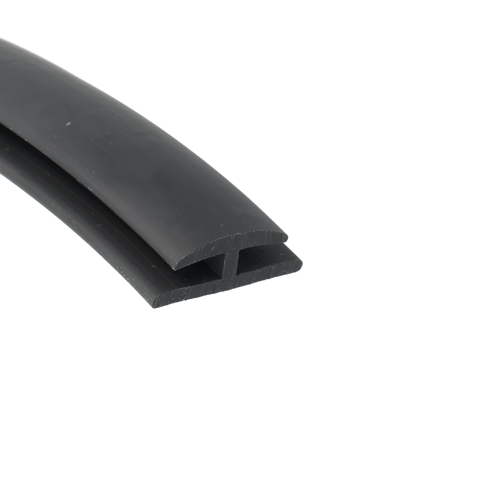 uszczelka-krawedziowa-typ-h-miekkie-pvc-4-x-20-x-27mm-czarna-12-321-1 - Centrum uszczelek Close-up of two black plastic extrusions with a rectangular hollow channel side by side.