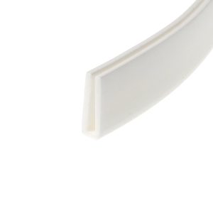 Close-up of a white decorative door frame corner with beveled molding and soft shadows along the angleed edge.