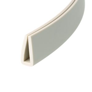 Close-up of a light gray plastic object with a rounded white edge and soft curves, viewed at an angle.