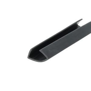 Close-up of a dark, rounded-edged blade or chisel-like tool extending diagonally across the frame.