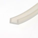 Close-up of a pale beige diagonal metal railing against a white background.