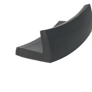 Close-up of a dark curved wooden piece with an angled edge, set against a white background.