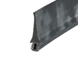Close-up of a black rubber weatherstripping seal with a foam core and jagged edge near the bottom