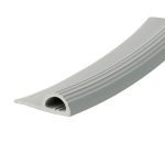 Close-up of a light gray ribbed plastic gutter cross-section with circular holes along the bottom edge, used for rainwater drainage.