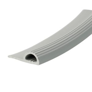 Close-up of a light gray ribbed plastic gutter cross-section with circular holes along the bottom edge, used for rainwater drainage.