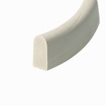 Close-up of a light gray curved foam object with a beige porous end on a white background