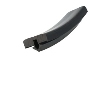 Close-up of a curved black machine blade with a square mounting hole for attachment