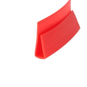Close-up of a bright red plastic strip folded into a curved V-shape against a white background.