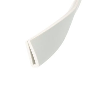 Close-up of a curved white plastic object running diagonally across a white background