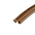 Close-up of a brown chocolate wafer stick with hollow square holes on a white background, angled diagonally.