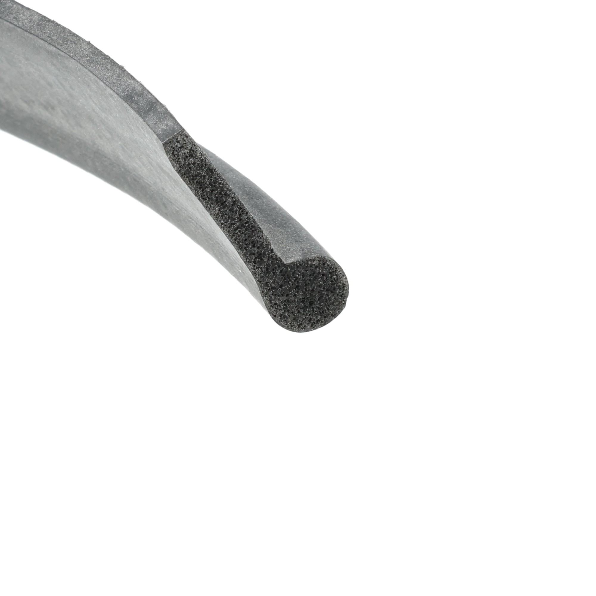 uszczelka-drzwi-pianka-silikonowa-typ-p-3-x-8-x-26mm-czarna-32-815-2 - Centrum uszczelek Close-up of a metal file with a rough, gritty edge and fine abrasive texture.