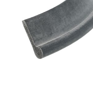 Close-up of a dusty dark gray sanding belt edge against a white background, showing rough grit.