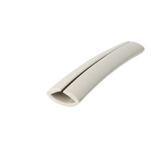 Close-up of a white curved plastic object with a smooth surface, showing a recessed groove along its length.