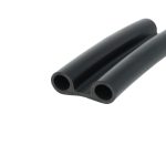 Three black hollow cylindrical tubes arranged diagonally, viewed from the side (close-up). We see smooth surfaces and circular openings.