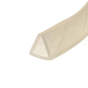 Close-up of a beige curved edge of cardboard or folded material against a white background, abstract composition.