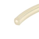 Beige plastic strap with a rounded end and two circular holes, diagonally across a white background.