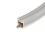 Close-up of a white plastic channel with beige interior fins, diagonally across the lower-right corner.