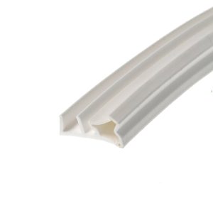 Close-up of a diagonal white corrugated channel or trim with soft gray edges, viewed at an angle.