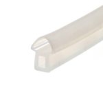 Close-up of a white plastic object with a curved edge and a circular knob, photographed at an angle.