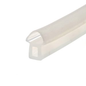 Close-up of a white plastic object with a curved edge and a circular knob, photographed at an angle.