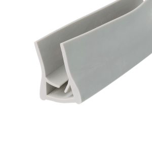 Close-up of a gray plastic clip or bracket with a curved outer edge and internal notch.